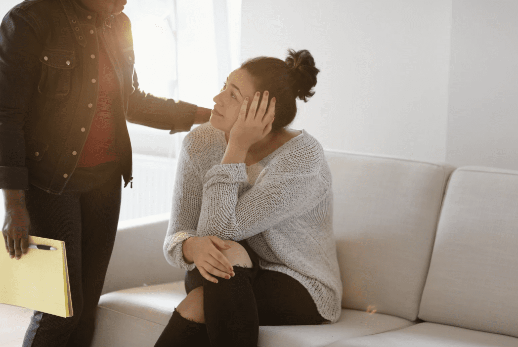 A woman comforting another woman.